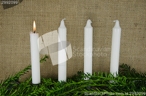 Image of Four advent candles at a background of burlap