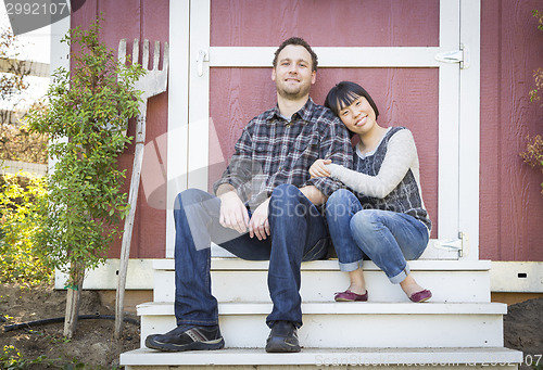 Image of Mixed Race Couple Relaxing on the Steps