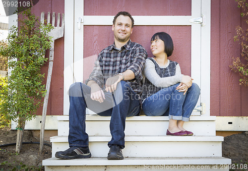 Image of Mixed Race Couple Relaxing on the Steps