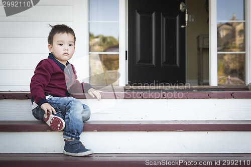 Image of Melancholy Mixed Race Boy Sitting on Front Porch Steps