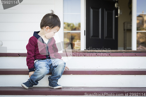 Image of Melancholy Mixed Race Boy Sitting on Front Porch Steps