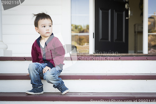 Image of Melancholy Mixed Race Boy Sitting on Front Porch Steps