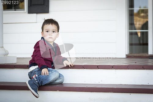 Image of Melancholy Mixed Race Boy Sitting on Front Porch Steps