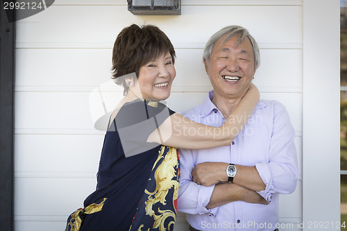 Image of Attractive Chinese Couple Enjoying Their House