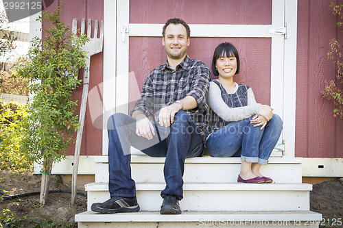 Image of Mixed Race Couple Relaxing on the Steps