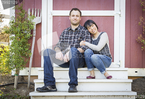 Image of Mixed Race Couple Relaxing on the Steps