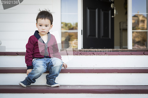 Image of Melancholy Mixed Race Boy Sitting on Front Porch Steps