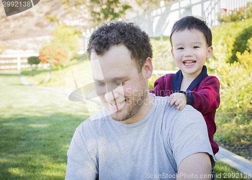 Image of Caucasian Father Having Fun with His Mixed Race Baby Son