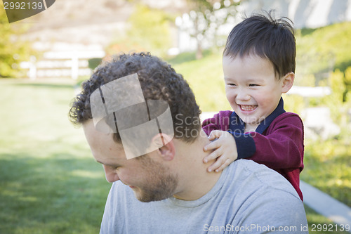 Image of Caucasian Father Having Fun with His Mixed Race Baby Son