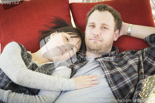 Image of Mixed Race Couple Relaxing in a Hammock
