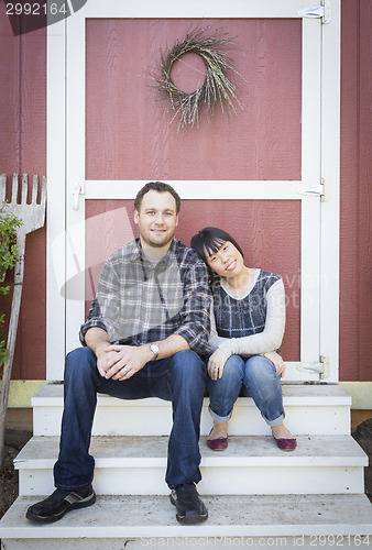 Image of Mixed Race Couple Relaxing on the Steps