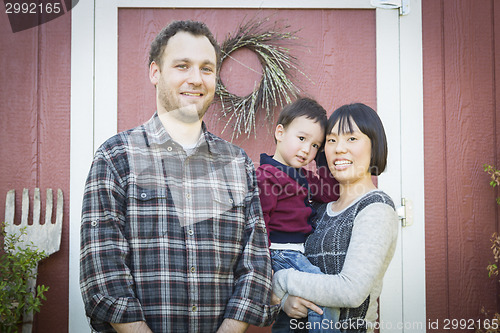 Image of Mixed Race Family Having Fun Outside