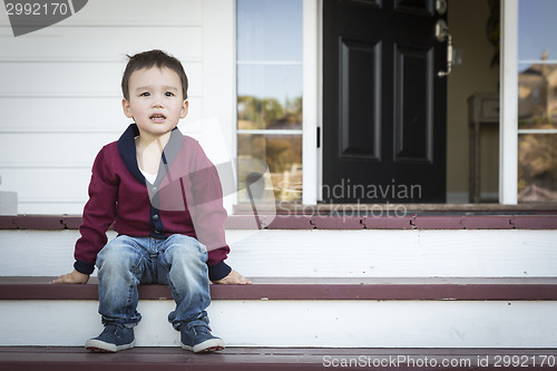 Image of Melancholy Mixed Race Boy Sitting on Front Porch Steps