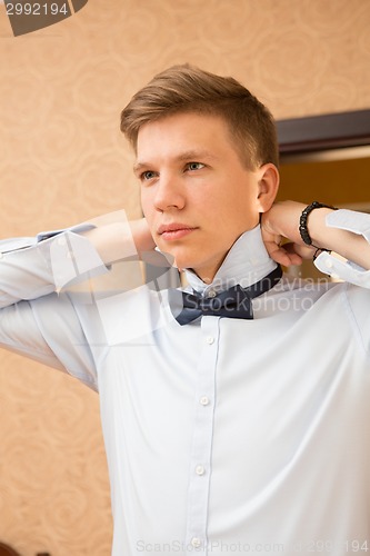 Image of Elegant young handsome groom. Fashion portrait.