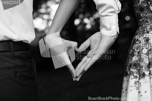 Image of Bride and groom standing together with heart