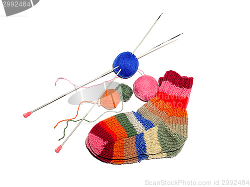 Image of Warm knitted woolen socks knitting needles isolated on a white b