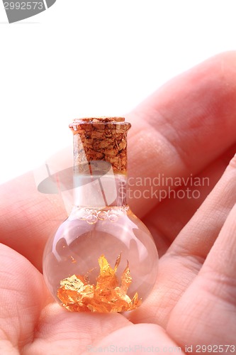 Image of gold in small glass bottle 