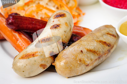 Image of German sausage with cabbage and sauces