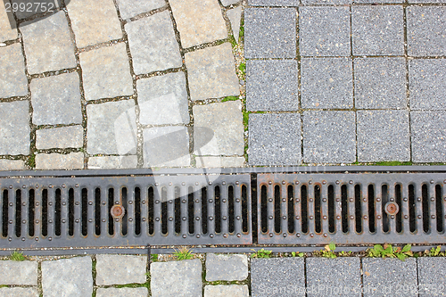 Image of drain and stone pavement