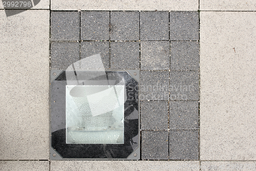 Image of light source on stone pavement