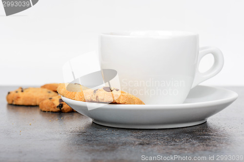 Image of Cup of coffee with cookies on table