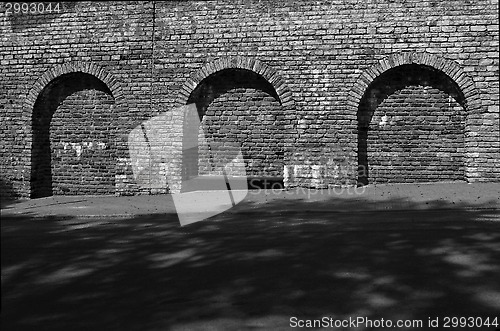 Image of stone wall with three arches in the medieval town