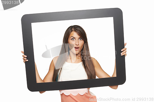 Image of Excited woman looking through tablet frame