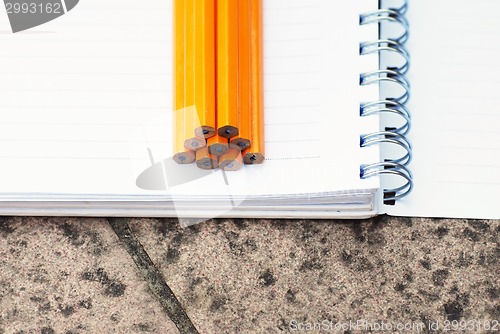 Image of Note book and pencils