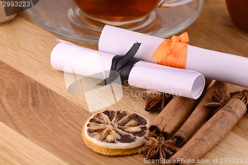 Image of hot tea with lemon and cinnamon on wooden backgroubd