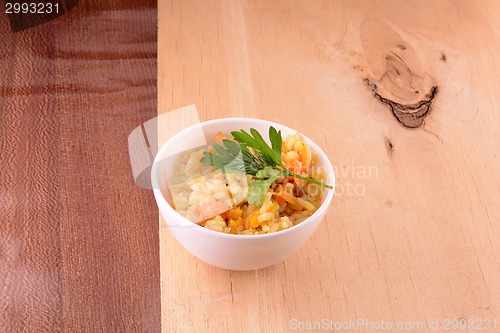 Image of Chinese cuisine - fried rice with meat on wooden background