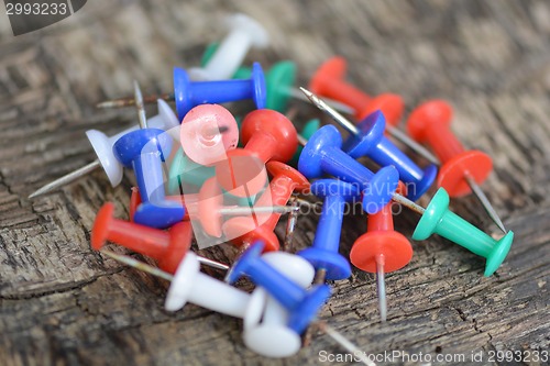 Image of old push pins set on old wooden background