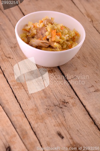 Image of Chinese cuisine - fried rice with meat on wooden background