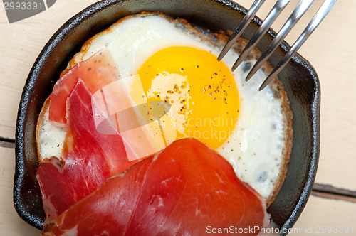 Image of egg sunny side up with italian speck ham