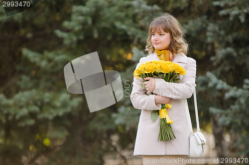 Image of Cute little girl with yellow roses awaiting appointment