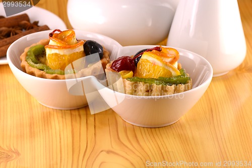 Image of Chocolate cake with cherry and olive on white plate