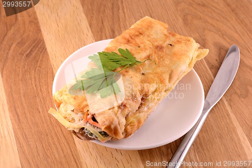 Image of burritos wraps with meat beans on wood board