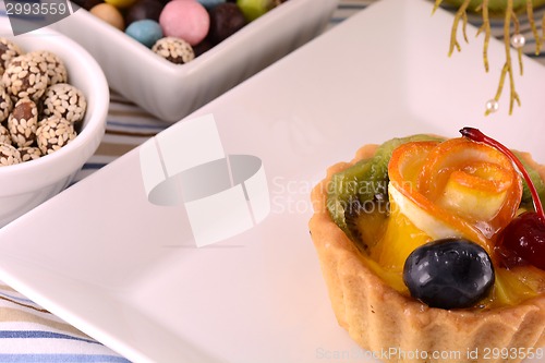 Image of Chocolate cake with cherry and olive on white plate