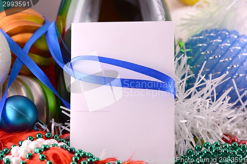 Image of Christmas background with wine bottle pearls and empty paper note