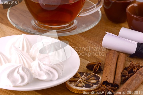 Image of hot tea with lemon and cinnamon on wooden backgroubd