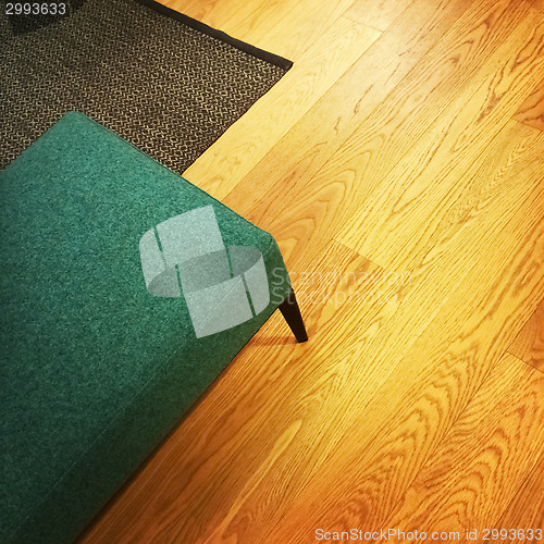 Image of Green stool on wooden floor