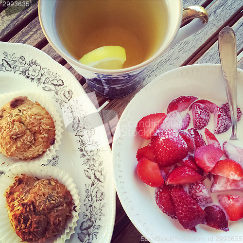 Image of Cup of tea with pastry and strawberries