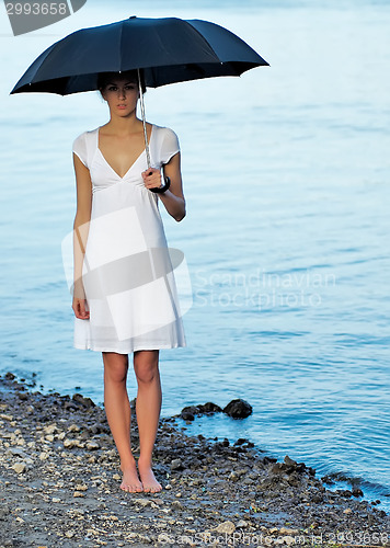 Image of Attractive woman under umbrella