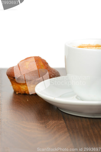 Image of Half cup of coffee with cupcake on table