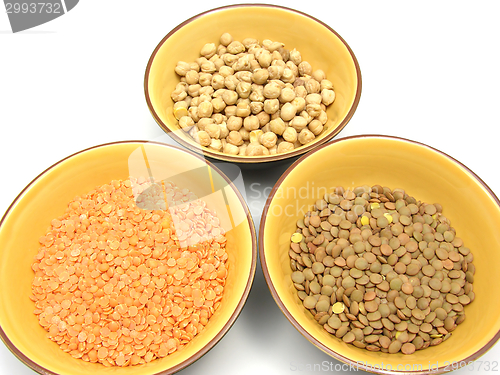 Image of Three bowls of ceramic with garbanzos lentils and red lentils