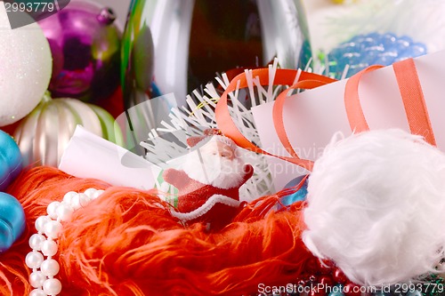 Image of Christmas background with wine bottle pearls and santa claus