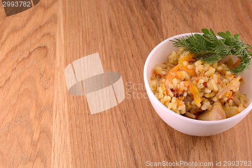 Image of Chinese cuisine - fried rice with meat on wooden background