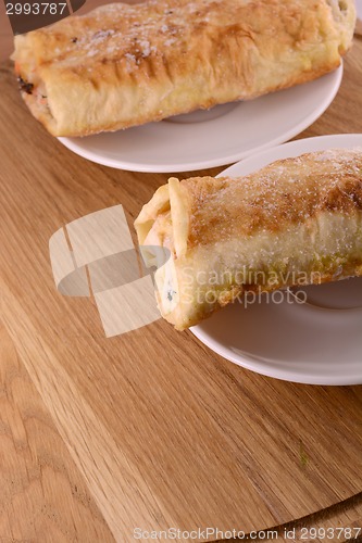 Image of burritos wraps with meat beans and vegetables on wood board