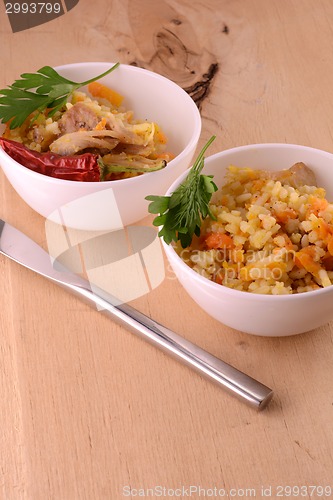 Image of Chinese cuisine - fried rice with meat on wooden background