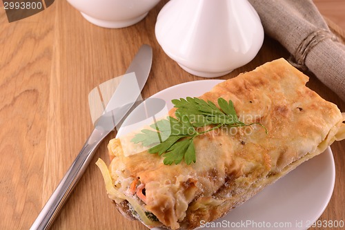 Image of burritos wraps with meat beans and vegetables on wood board