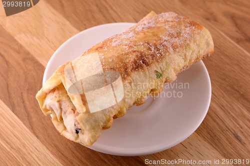 Image of burritos wraps with meat beans and vegetables on wood board